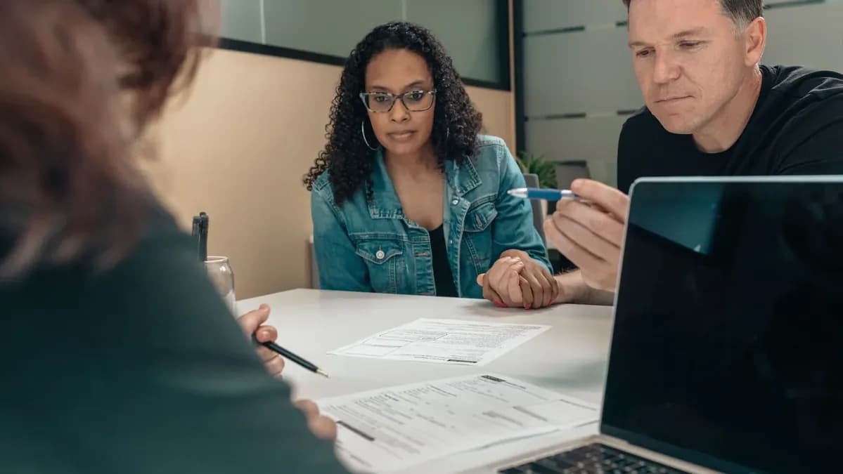 People review documents together at a table.