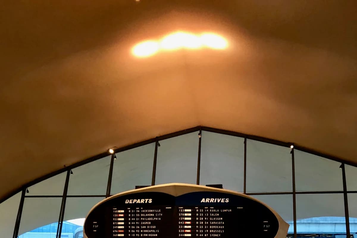 A real departure display at the historic TWA Flight Center at JFK, photographed in 2019; it is not current timetable or fare data.