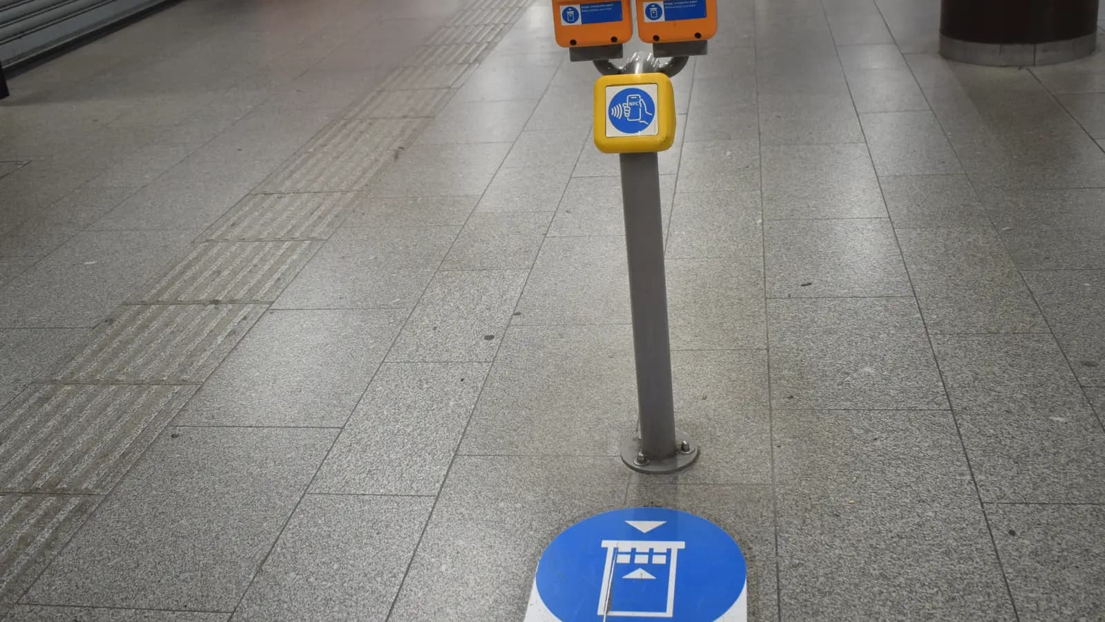 Public transport ticket validators in a metro station.