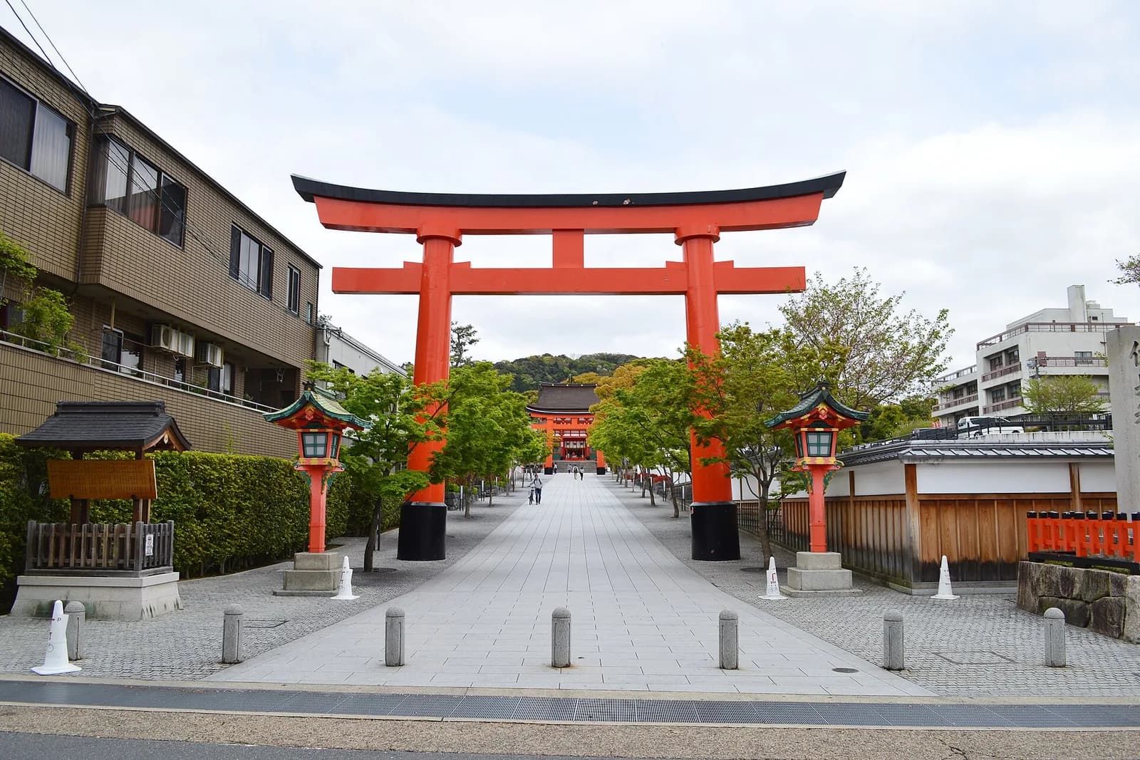 A large vermilion torii gate at the approach to Fushimi Inari Taisha in Kyoto.