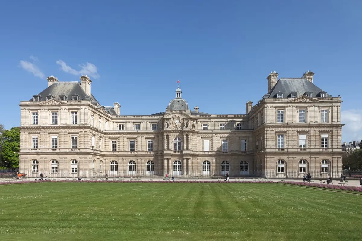 The Luxembourg Palace seen from the lawn of the Luxembourg Gardens on a sunny day.