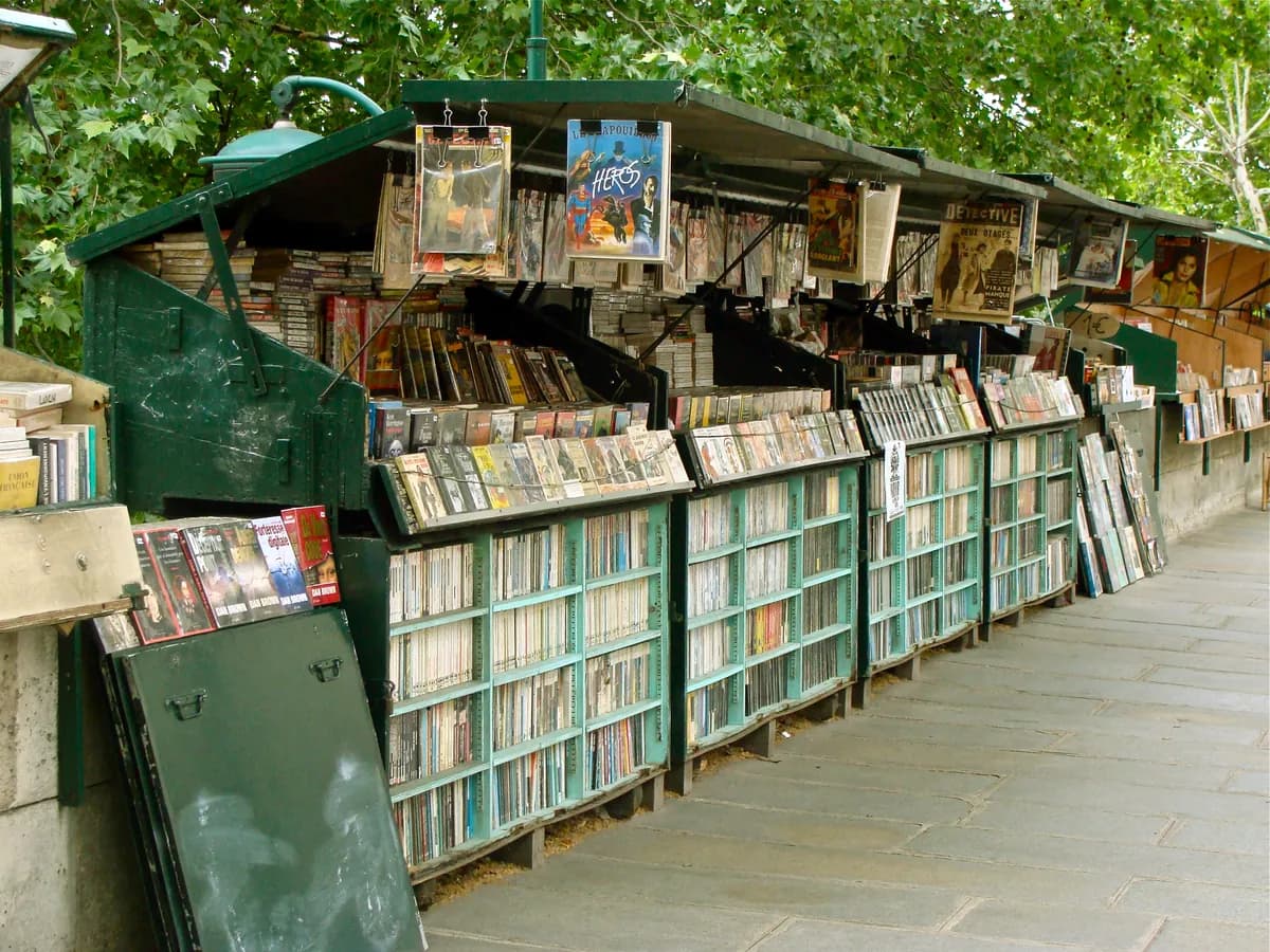 Green bouquiniste stalls with second-hand books beside the Seine in Paris.