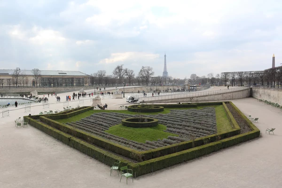 Flowerbeds of the Tuileries Garden with the Place de la Concorde and the Eiffel Tower in the distance.