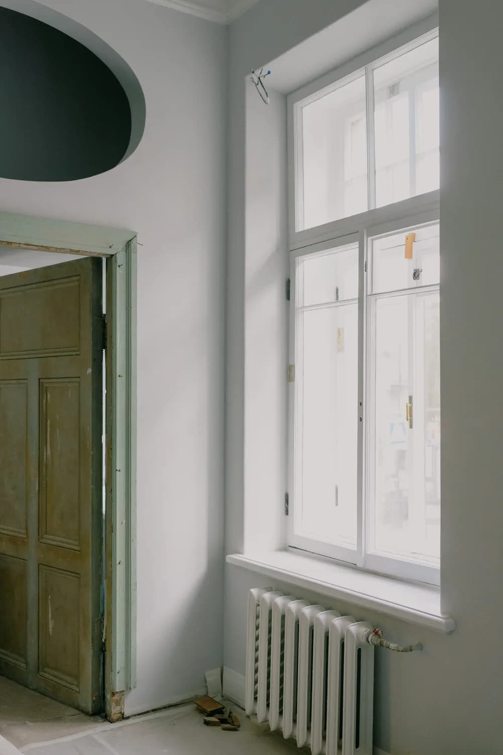 Bright window above a white radiator in a home.